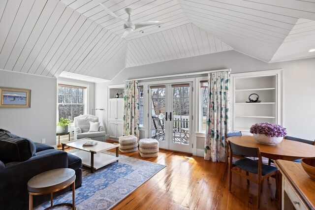 living room featuring wooden ceiling, light hardwood / wood-style floors, built in features, french doors, and ceiling fan