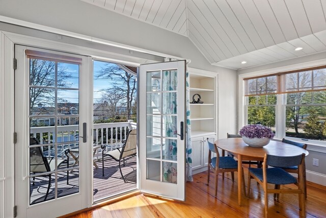 entryway featuring built in features, light hardwood / wood-style floors, and lofted ceiling