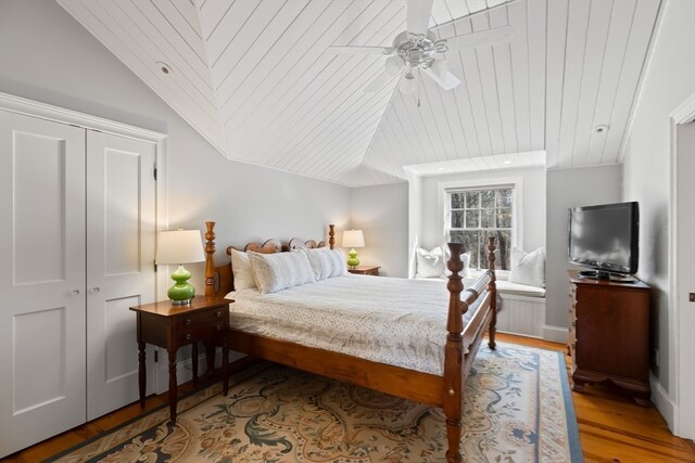 bedroom with a closet, ceiling fan, vaulted ceiling, and light hardwood / wood-style flooring