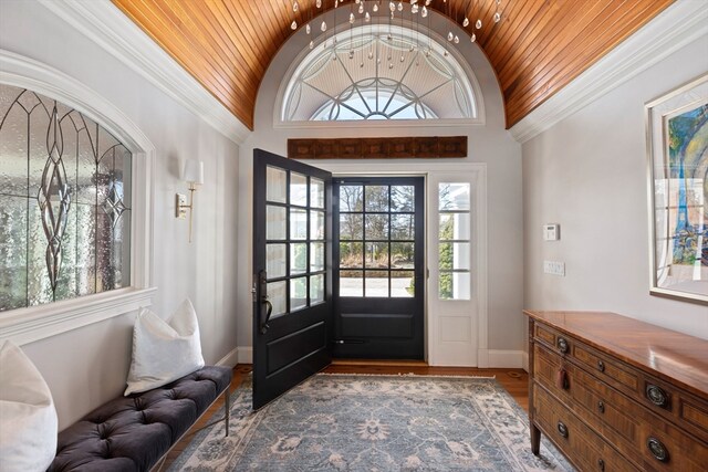 entryway featuring crown molding, hardwood / wood-style floors, and wooden ceiling