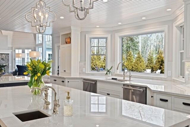 bar featuring light stone countertops, a notable chandelier, white cabinetry, and dishwasher