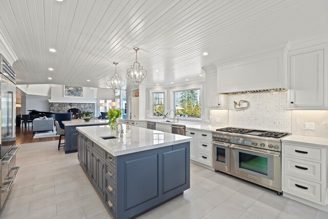 kitchen with wooden ceiling, decorative light fixtures, white cabinets, stainless steel appliances, and a notable chandelier