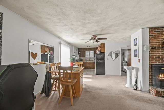 10 Gleason Rd, Shrewsbury, MA 01545 - dining area featuring ceiling fan, a textured ceiling, carpet, and a brick fireplace