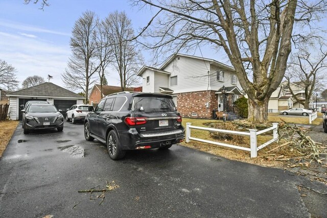 10 Gleason Rd, Shrewsbury, MA 01545 - view of side of property featuring a detached garage, brick siding, and an outbuilding