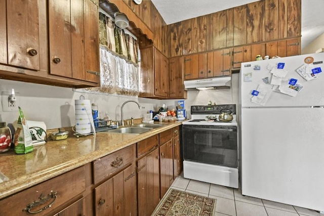 10 Gleason Rd, Shrewsbury, MA 01545 - kitchen with white appliances, under cabinet range hood, light tile patterned floors, and brown cabinetry