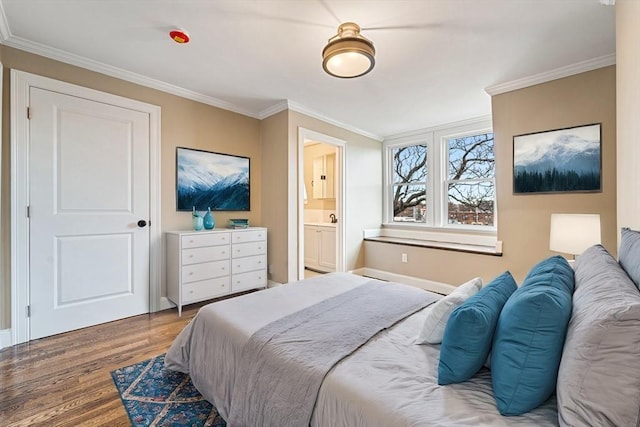 bedroom with wood-type flooring, connected bathroom, and crown molding