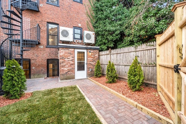 back of house featuring ac unit, a yard, and a patio