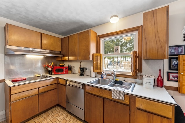 kitchen with light countertops, stainless steel dishwasher, a sink, and under cabinet range hood