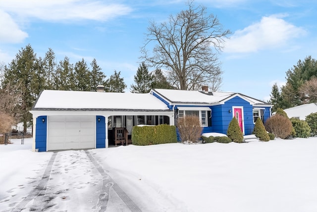 ranch-style home featuring a chimney and an attached garage