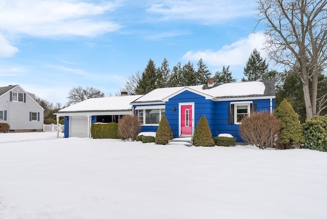 single story home with a garage and a chimney