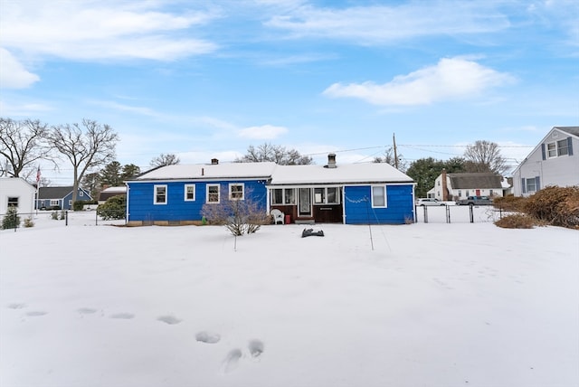 view of snow covered rear of property