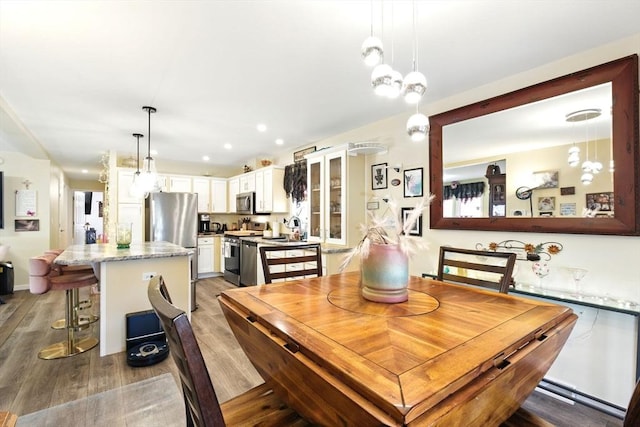 dining room featuring recessed lighting and light wood-type flooring