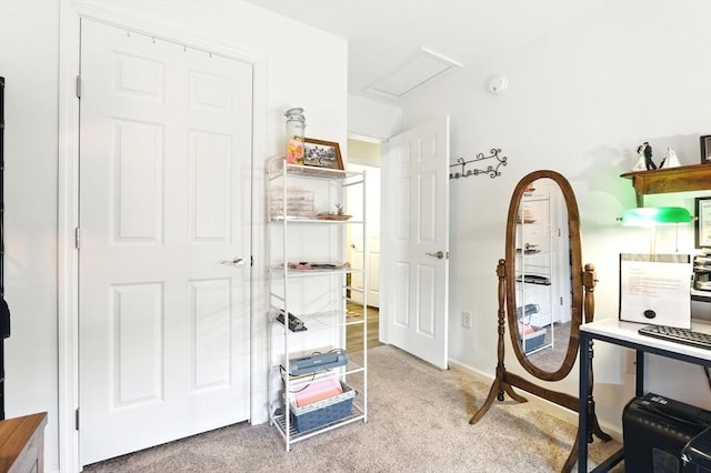 carpeted home office featuring attic access