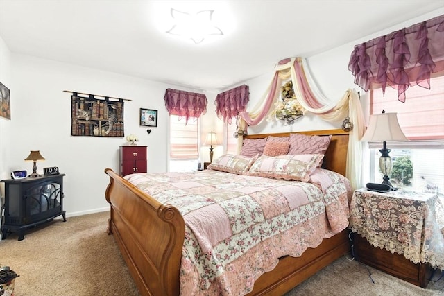 carpeted bedroom with a wood stove and baseboards