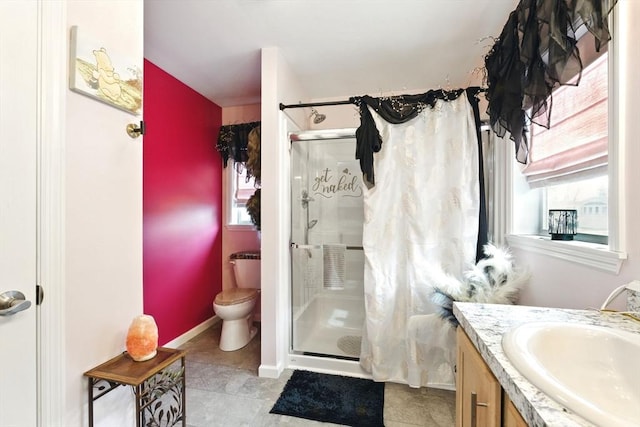 bathroom with a wealth of natural light, a stall shower, and vanity