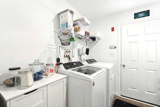 laundry room featuring cabinet space and independent washer and dryer