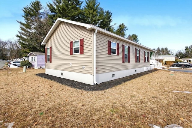 view of property exterior featuring a lawn and crawl space