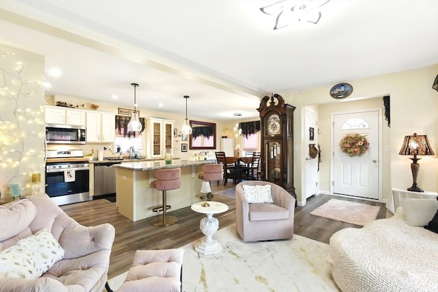 living area with baseboards and dark wood-style flooring