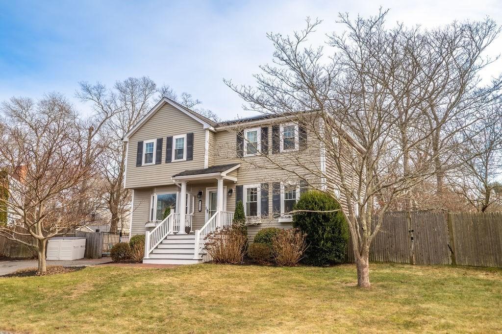 view of front of house with a storage shed and a front lawn