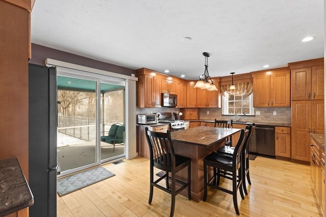 dining room featuring sink and light wood-type flooring