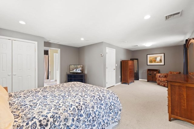 bedroom with a closet and light carpet