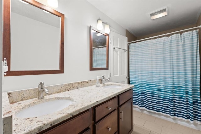 bathroom with vanity and a shower with shower curtain