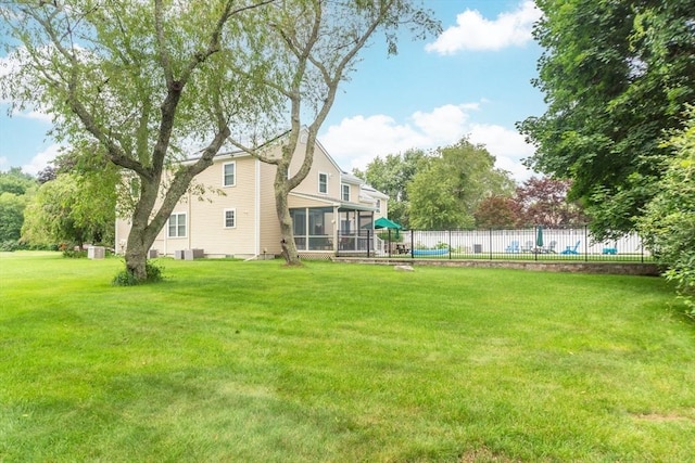 view of yard featuring cooling unit and a sunroom