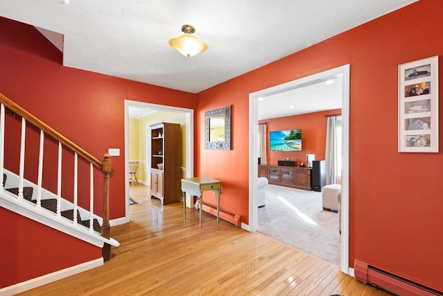 entrance foyer featuring hardwood / wood-style floors and baseboard heating