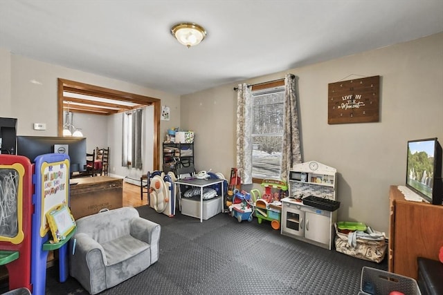 playroom featuring a baseboard heating unit