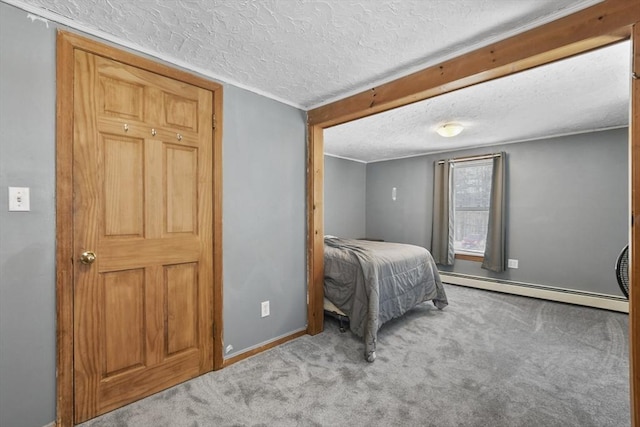 bedroom with baseboard heating, carpet flooring, a textured ceiling, and baseboards