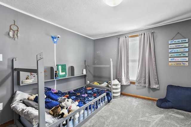 carpeted bedroom featuring baseboards and a textured ceiling