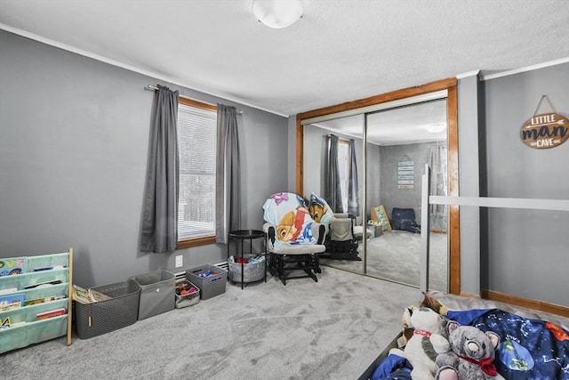 interior space featuring a textured ceiling, carpet floors, and ornamental molding