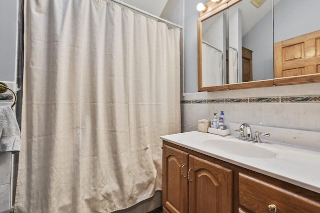 bathroom featuring vanity, tile walls, and a shower with shower curtain