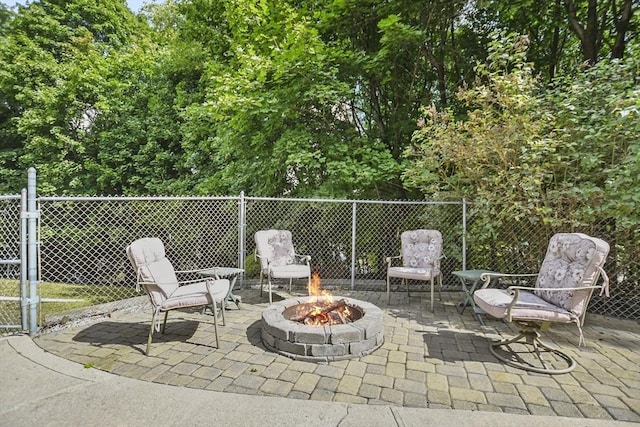 view of patio / terrace with an outdoor fire pit and fence