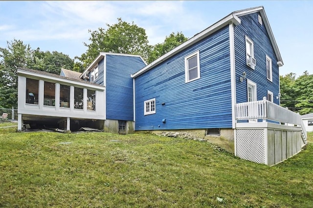 back of house with a yard and a sunroom