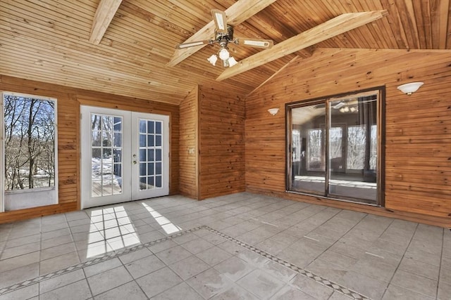 interior space featuring lofted ceiling with beams, french doors, wooden ceiling, and a ceiling fan