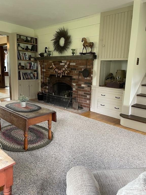 33 Whittemore St, Leicester, MA 01524 - living area with a fireplace, stairway, and wood finished floors