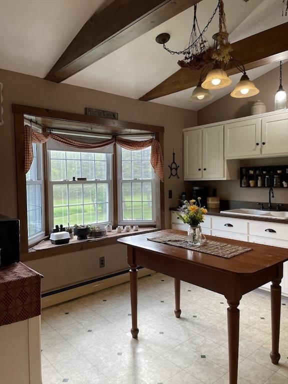 33 Whittemore St, Leicester, MA 01524 - kitchen featuring baseboard heating, white cabinets, a sink, dark countertops, and decorative light fixtures