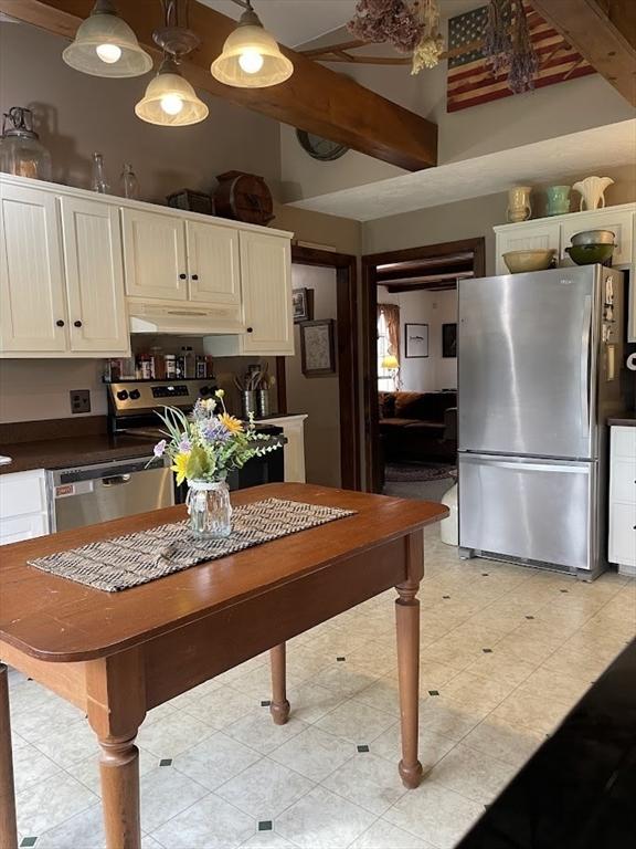 33 Whittemore St, Leicester, MA 01524 - kitchen featuring stainless steel appliances, dark countertops, under cabinet range hood, white cabinetry, and a towering ceiling