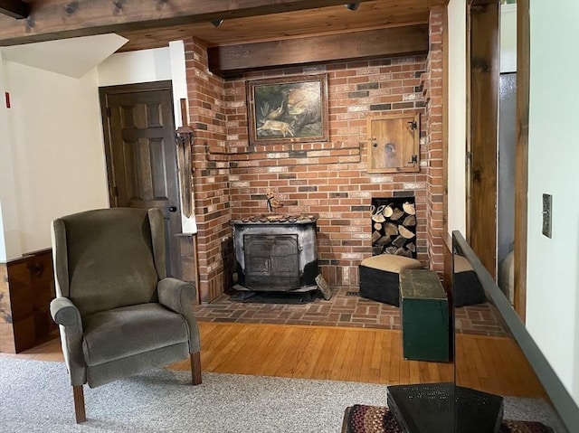 33 Whittemore St, Leicester, MA 01524 - living area with a wood stove, wood finished floors, and beamed ceiling