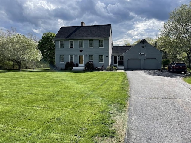 33 Whittemore St, Leicester, MA 01524 - colonial house featuring an attached garage, a chimney, asphalt driveway, and a front yard