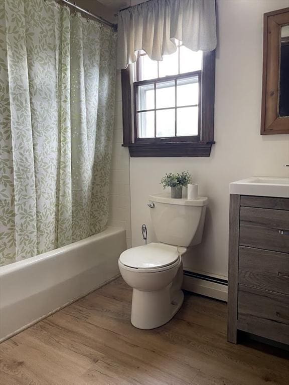 33 Whittemore St, Leicester, MA 01524 - full bath with a baseboard radiator, toilet, vanity, shower / bath combo, and wood finished floors
