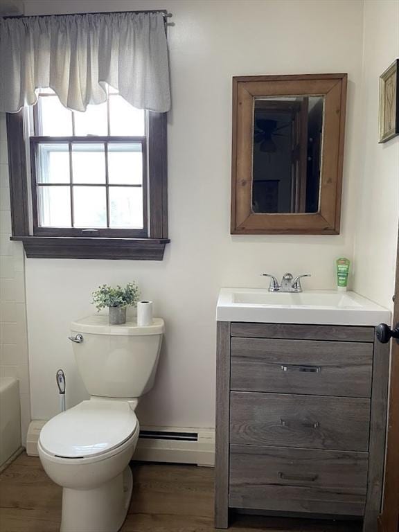 33 Whittemore St, Leicester, MA 01524 - bathroom featuring a baseboard radiator, vanity, wood finished floors, and toilet