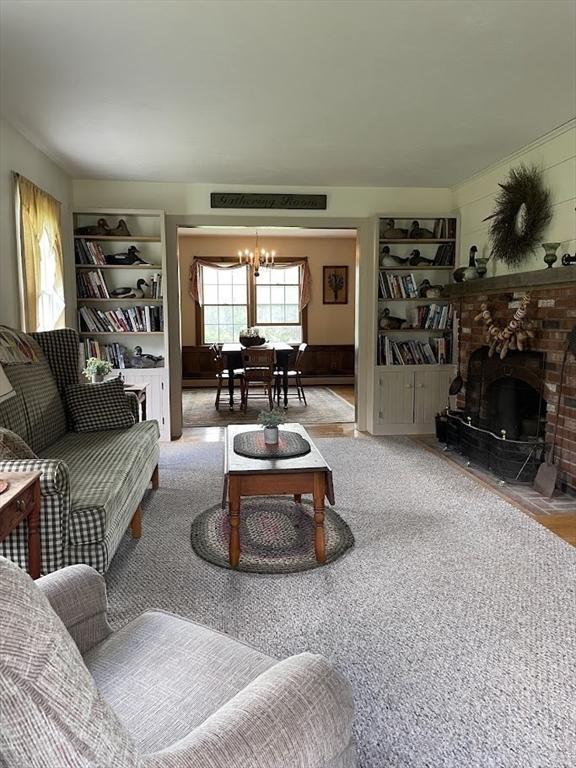 33 Whittemore St, Leicester, MA 01524 - living room featuring a chandelier, a fireplace, and built in shelves