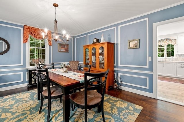 153 Old Connecticut Path, Wayland, MA 01778 - dining space with a decorative wall, a chandelier, dark wood-style flooring, and crown molding
