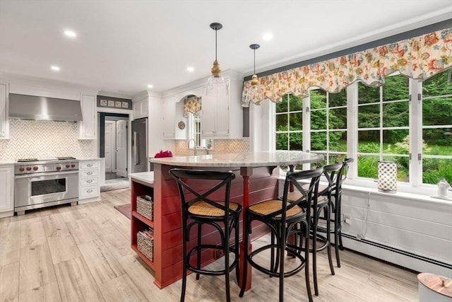 153 Old Connecticut Path, Wayland, MA 01778 - kitchen featuring appliances with stainless steel finishes, wall chimney exhaust hood, white cabinetry, decorative backsplash, and recessed lighting