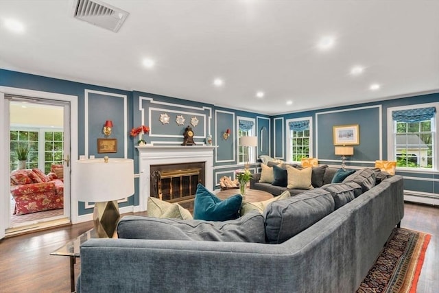 153 Old Connecticut Path, Wayland, MA 01778 - living room featuring a decorative wall, dark wood-style flooring, healthy amount of natural light, a glass covered fireplace, and recessed lighting