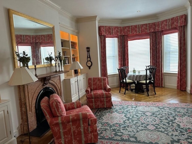 sitting room with baseboards, wood finished floors, ornamental molding, and a brick fireplace