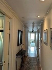 hall with crown molding and baseboards