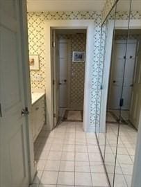 bathroom featuring wallpapered walls and tile patterned floors